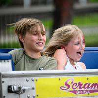 Employees and their families enjoy rides, games and food during the annual TQL Summer Picnic at Kings Island Amusement Park on June 27 in Mason, Ohio.