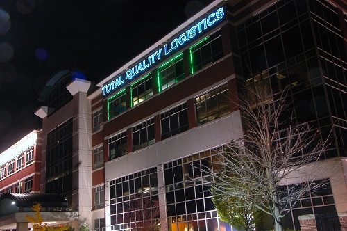 TQL building with green lights around windowsills