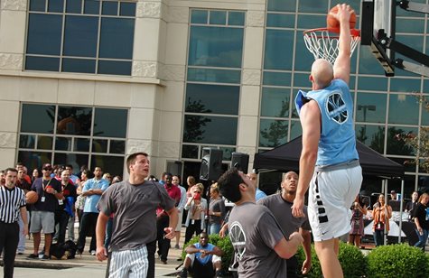 A Man Wearing A Blue Shirt Dunks A Basketball In The TQL 3-on-3 Tournament