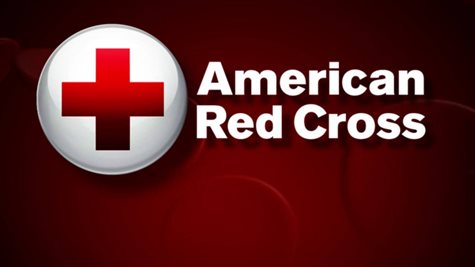American Red Cross Logo In Front Of A Dark Red Background