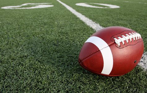 A Football Placed On The 50 Yard Line Of A Football Field