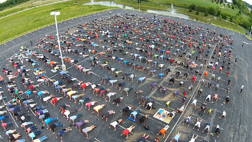 An Aerial View Of The TQL Parking Lot, Filled With Employees Doing Pushups