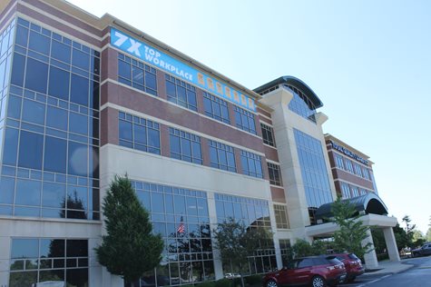 The Front Of The TQL Building With A Banner Hanging From The Top