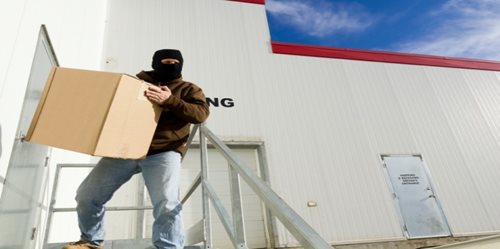 Masked Man Stealing Box from a wharehouse