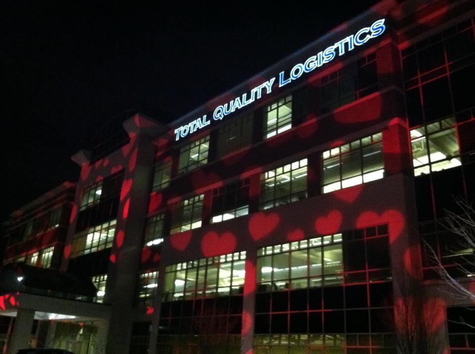 TQL building with projected red hearts