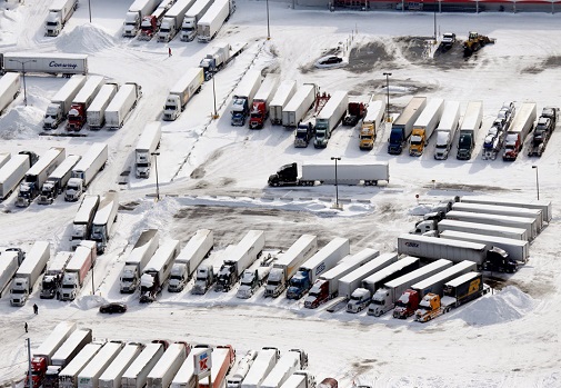 Parked Semi trucks in a snow covered lot