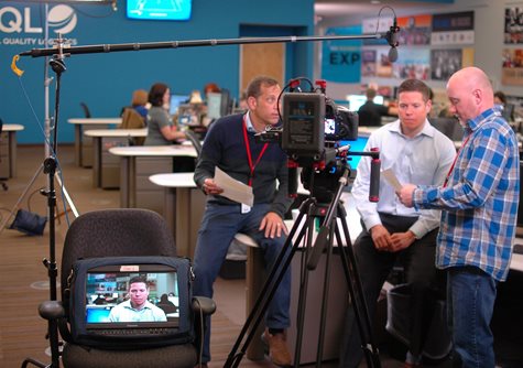 Three Men Read Through A Script For A Video