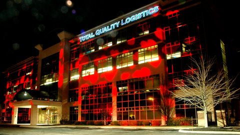 TQL Building With Hearts Projected On It During Nighttime