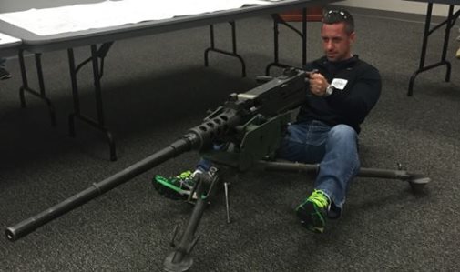 Man posing with military weapon