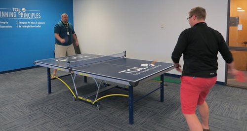 Two men playing table tennis