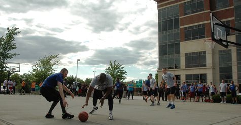 A Large Crowd Of People Watching Two Teams Play Basketball At TQL