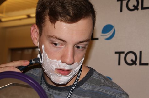 TQL Employee With Shaving Cream On His Face And Beginning to Shave