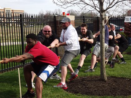 Men Tugging rope in tug of war