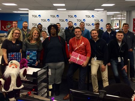 People holding gifts posing for a picture