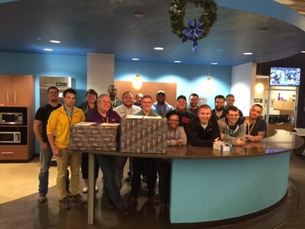 People around a counter with presents