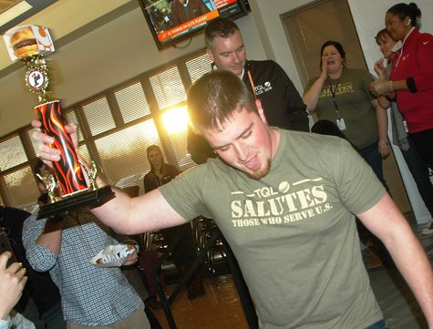 Man With Trophy Celebrates