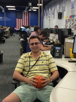 Man sitting at desk smiling at camera